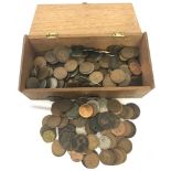 A box of assorted British coins, mainly pennies and half pennies.