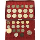 A collectors 2 tier case containing a collection of 8 x £5 coins and other British coins.