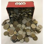 A tin of assorted foreign coins dating from 1920's - current.