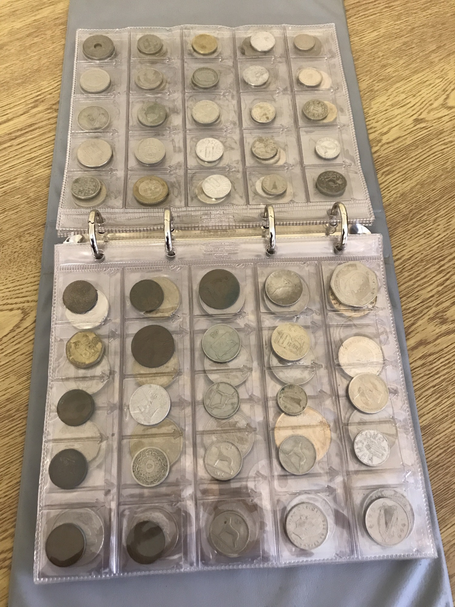 A collectors folder containing British, Commonwealth and world coins.