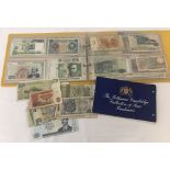 A collectors folder containing an assortment of foreign bank notes.