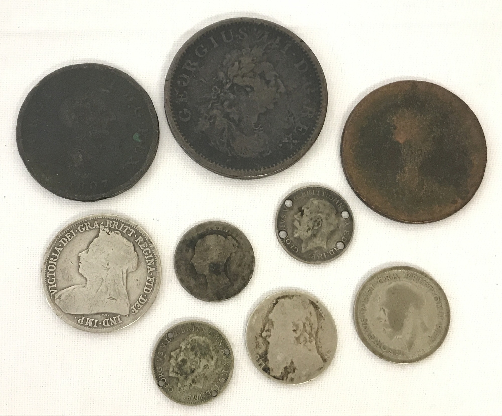 A small collection of British coins. To include George III penny and half penny.