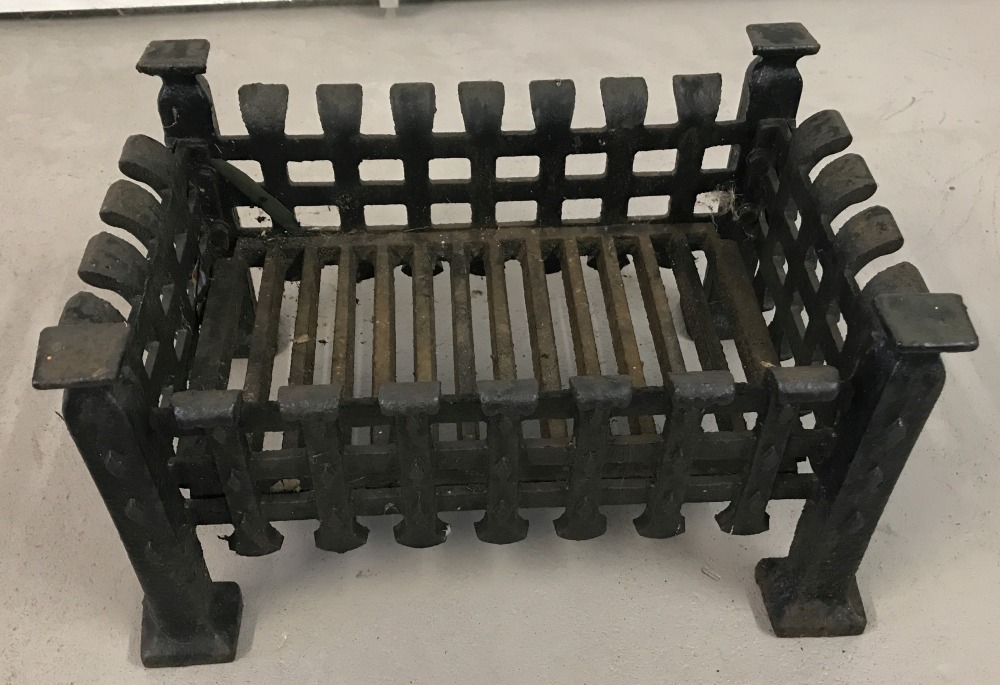 A vintage cast iron fire grate .