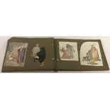 A photo album containing vintage fairy tale prints, animals and bird cut-outs.