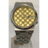 A boxed vintage Seiko Automatic 5 wrist watch with gold tone chequered face.