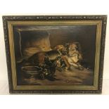 A gilt framed oil on board of a mother dog and her puppies.