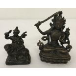 2 small bronze figures depicting Oriental deities.