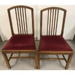 2 vintage matching dark wood dining chairs with red velvet upholstered seats.