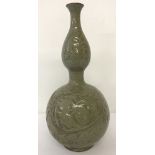 A large double gourd shaped, celadon glaze vase with floral patternation.