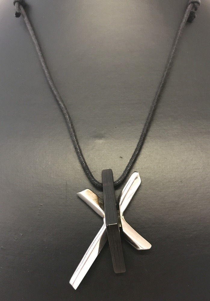 A contemporary design cross pendant on a black leather thong.