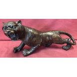 A hollow bronze figure of a roaring Tiger.