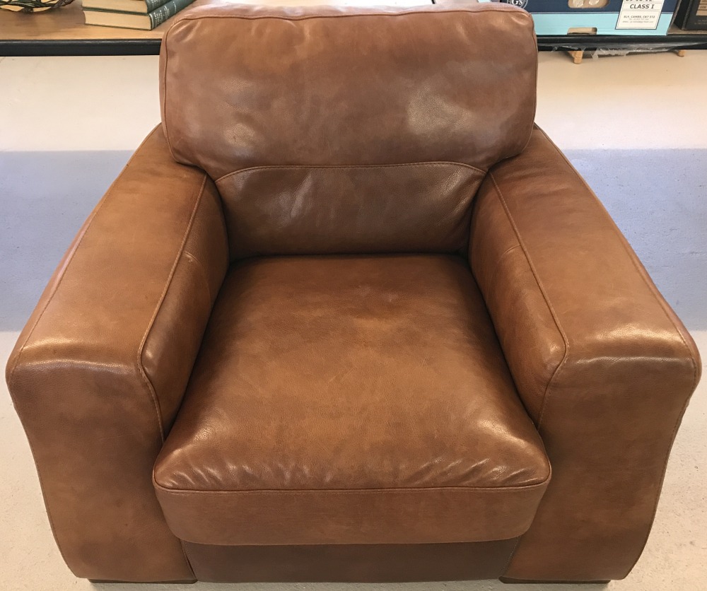 A large modern design Sofitallia armchair in tan leather with wooden feet.