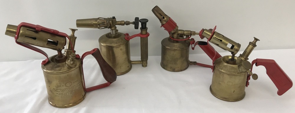 4 vintage brass blow lamps; handles and blower supports have been painted red.