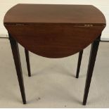 A vintage mahogany drop leaf occasional table raised on square tapered legs.