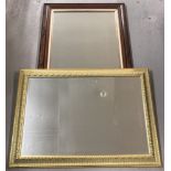 Two large framed wall mirrors.