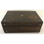 A small vintage wooden box with inlaid mother of pearl detail to top and front.