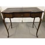 A vintage console table with serpentine front and tapered legs.