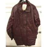 A 1980's ladies 3/4 length red/brown leather coat with zip and popper fastening.