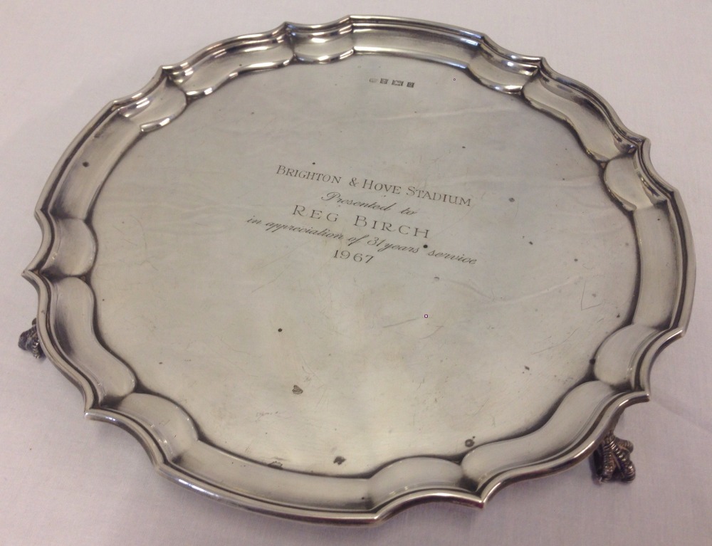 A claw and ball, 3 footed silver salver with inscription. Hallmarked Birmingham, 1965.