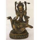 A gilded heavy metal figure of Vishnu set with turquoise and coral cabochons.