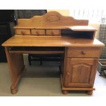 A modern pine dressing table/desk with curved upper shelf and 3 small drawers.