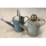 2 small vintage galvanised watering cans.