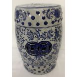 A large ceramic blue and white Oriental seat with floral detail and pierced work panels.