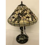 A tiffany style table lamp with leaded glass shade and lamp base.