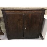 A vintage dark oak 2 door cupboard with interior shelves.