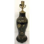 A Japanese black ceramic lamp base with gilt decoration.