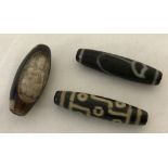 3 Tibetan dsi beads, one with engraved detail.