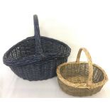 A blue wicker shopping basket together with a child's wicker shopping basket.