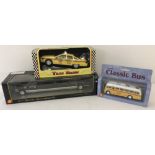 Three boxed Model diecast vehicles.