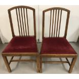 2 vintage matching dark wood dining chairs with red velvet upholstered seats.