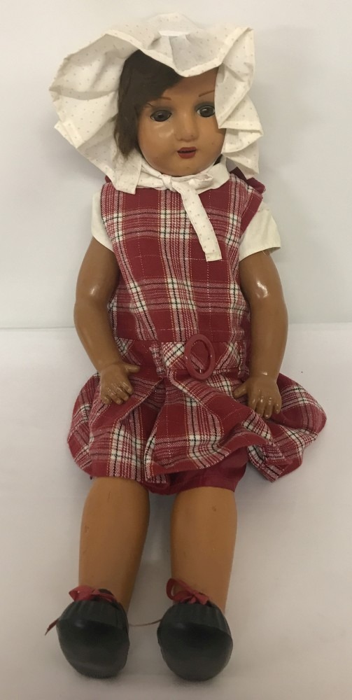 A large vintage composition doll. Jointed body, painted eyebrows and lips with open mouth.