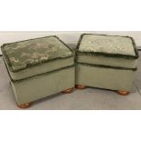 A matching pair of vintage upholstered footstools in green velour with pine bun feet.