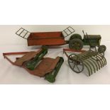 A vintage Mettoy, tin plate, wind up tractor and implements set.