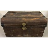 A Victorian metal travelling trunk with carry handles and brass latch/lock fixings.