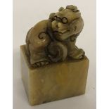 An Oriental square shaped, carved soapstone seal with foo dog detail.