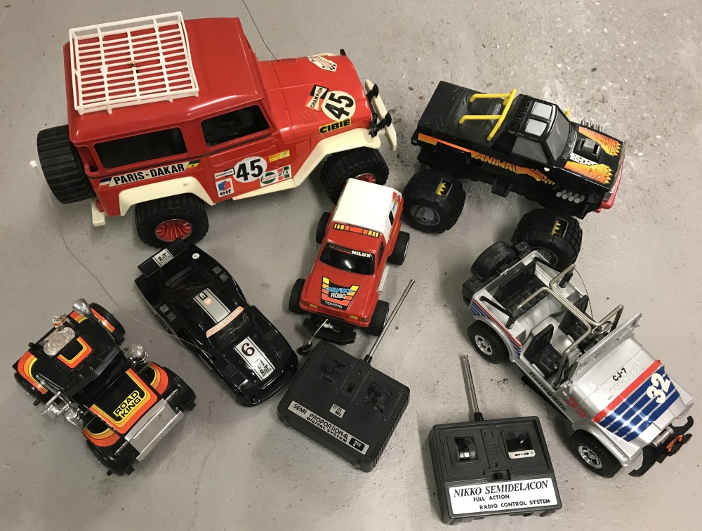 A box of remote control vehicles to include a monster truck and dune buggy.