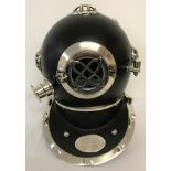 An ornamental black metal and chrome divers helmet.