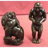 A Japanese dark wood erotic netsuke of an oriental gentleman.