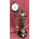 A bronze based figural, swinging pendulum mystery clock.