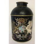 A black painted Tole ware, lidded tea jar with coat of arms detail to front.