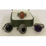 4 silver and white metal stone set dress rings.