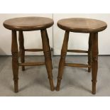 A pair of 4 legged elm wood stools with turned detail to legs.