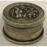 A Chinese white metal rouge pot with figural detail to lid.