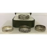 4 silver and white metal band rings.