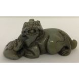 A carved jade figure of a Chinese Foo Dog.
