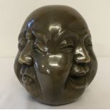 A brass paperweight of a 4 faced Buddha, signed to underside.
